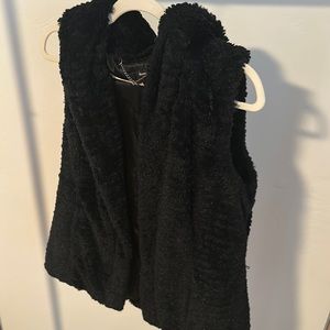 Gently used, like new. Black fur vest w/ hood & pockets